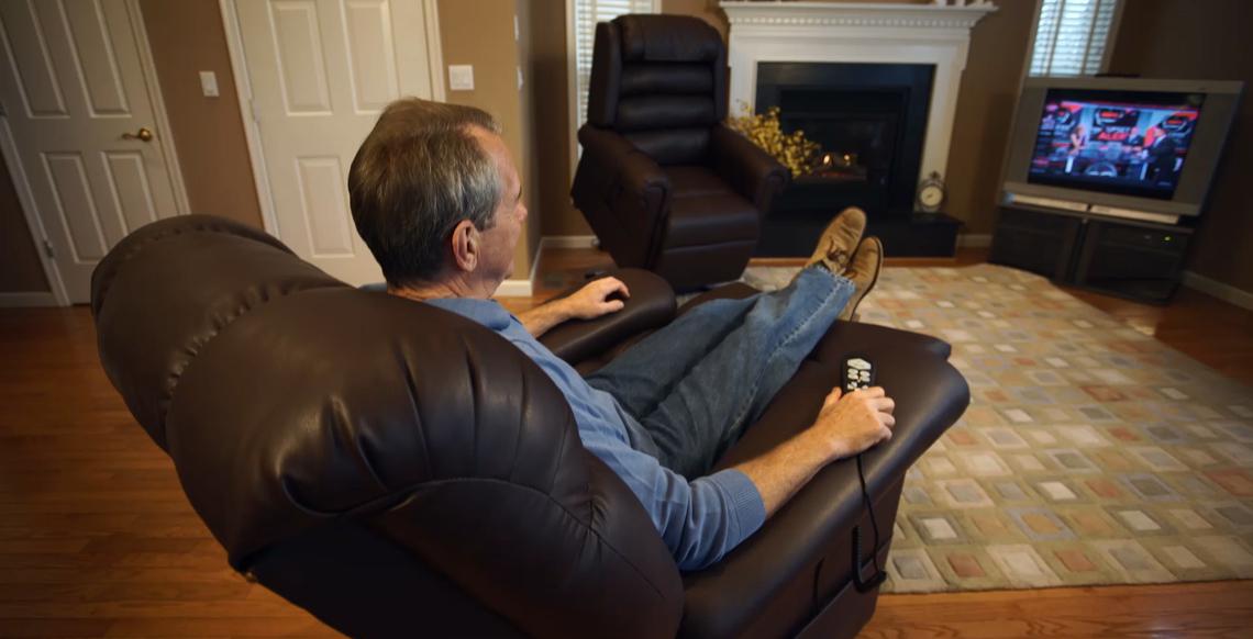 Man watches a TV in a Golden Technologies lift chair in a reclined position